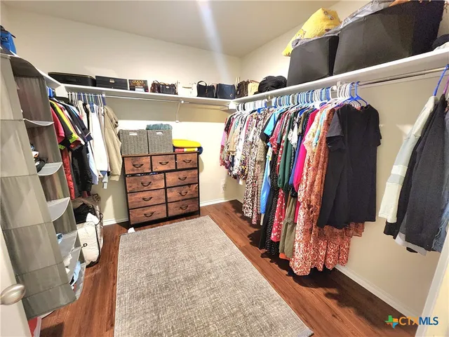 a spacious bathroom with a tub sink and mirror
