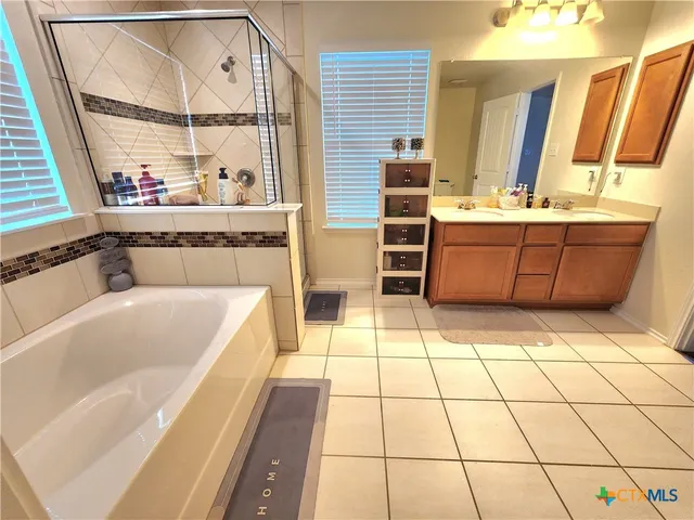 a bathroom with a sink a mirror and a bathtub