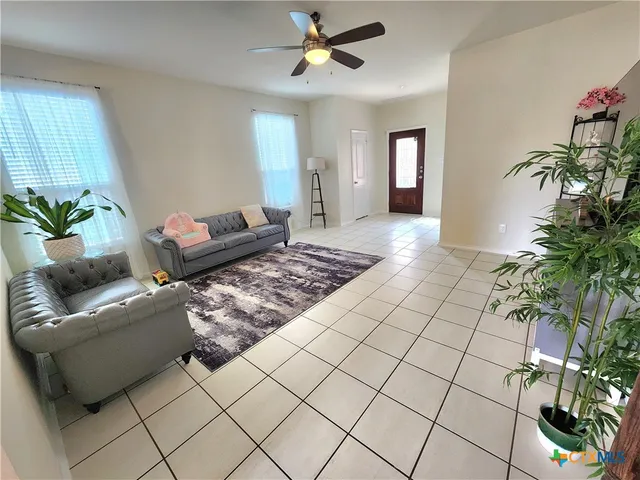 a living room with furniture and a potted plant