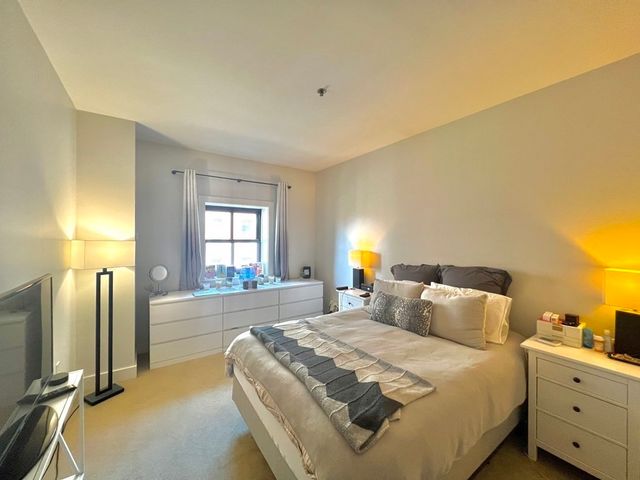 a bedroom with bed and window