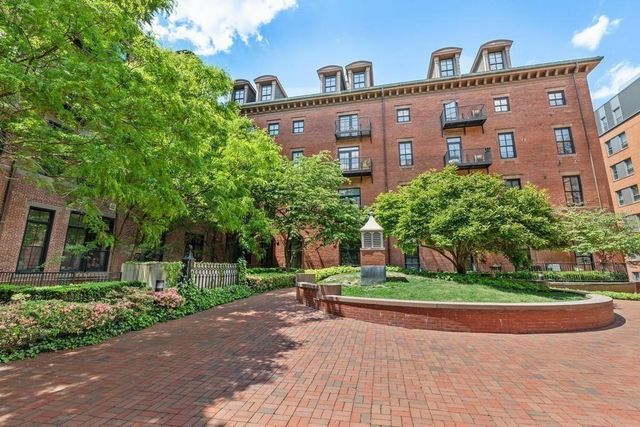 a front view of a building with garden
