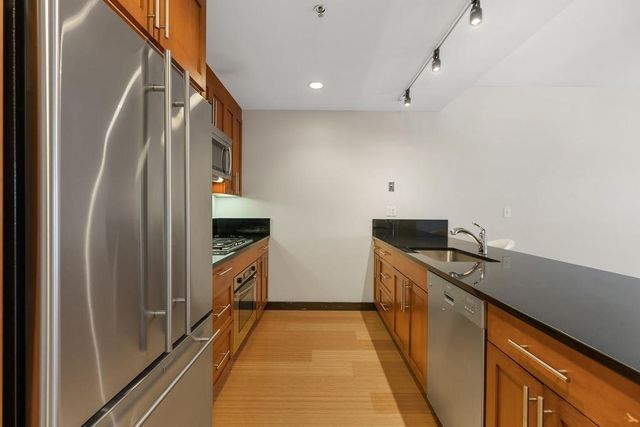 a kitchen with a sink and refrigerator