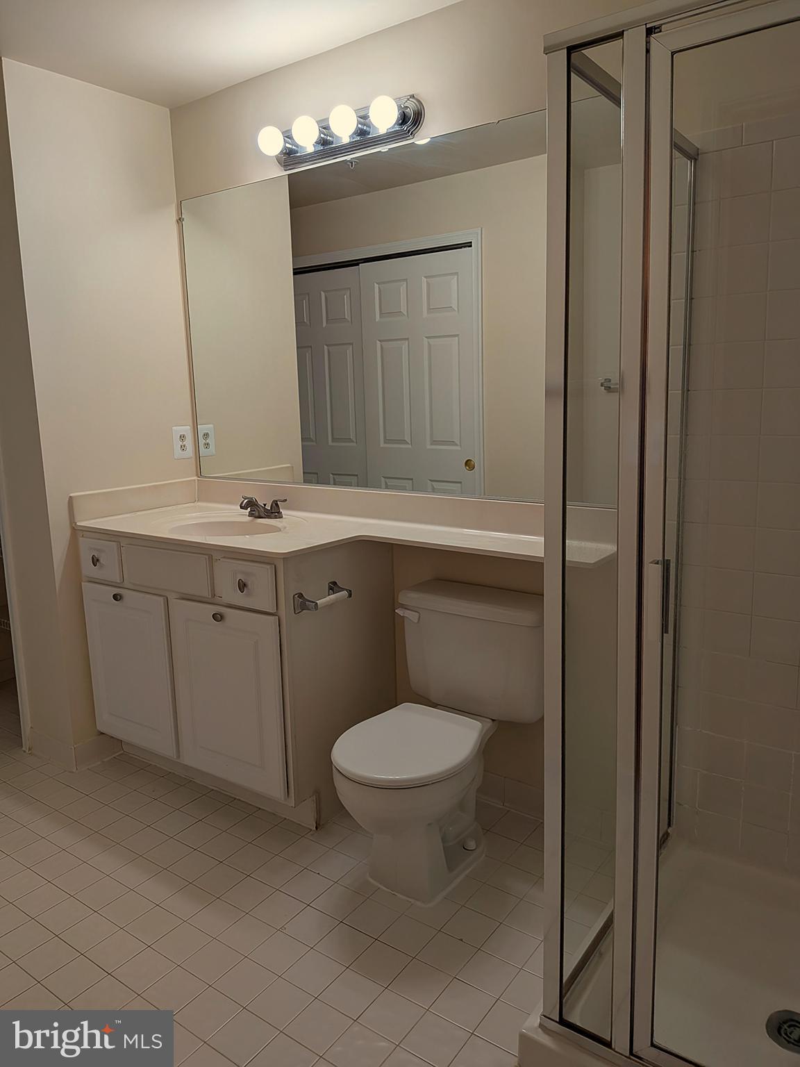 109 Timberbrook Lane, Unit 301 Gaithersburg, MD 20878 - Photo 16 of 22 a bathroom with a toilet sink and mirror