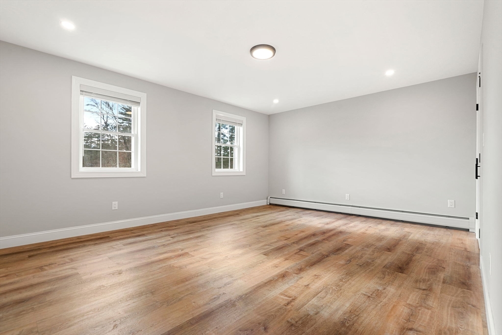 249 Brookside Road Orange, MA 01364 - Photo 15 of 37 a view of an empty room with wooden floor and a window