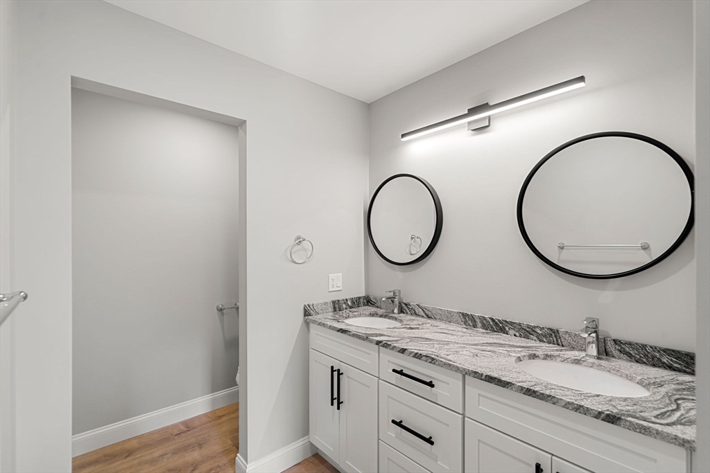 249 Brookside Road Orange, MA 01364 - Photo 21 of 37 a bathroom with a granite countertop double vanity sink and a mirror