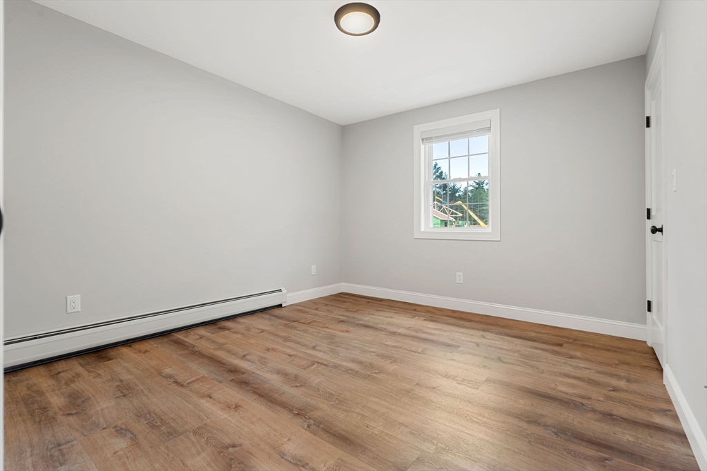 249 Brookside Road Orange, MA 01364 - Photo 22 of 37 an empty room with wooden floor and windows