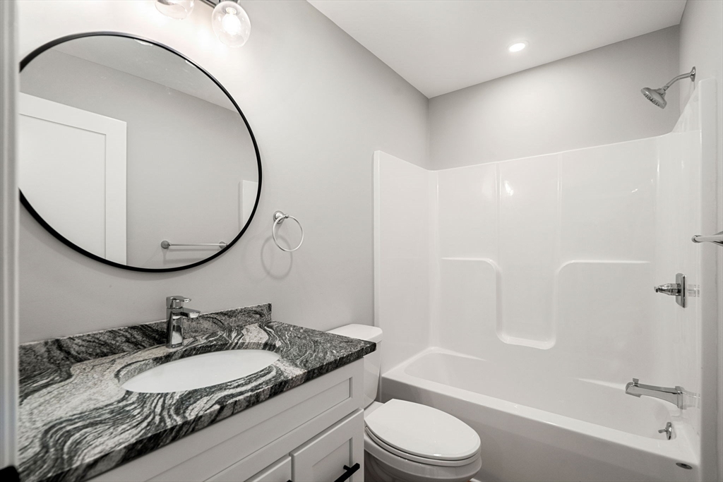 249 Brookside Road Orange, MA 01364 - Photo 25 of 37 a bathroom with a granite countertop sink mirror toilet and bathtub