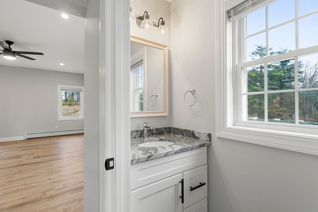 249 Brookside Road Orange, MA 01364 - Photo 28 of 37 a bathroom with a granite countertop sink and a mirror