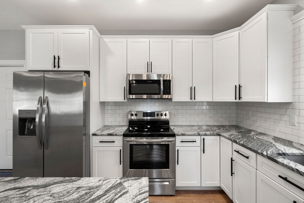 249 Brookside Road Orange, MA 01364 - Photo 8 of 37 a kitchen with a refrigerator stove and microwave