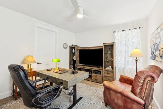 a view of a room with furniture and wooden floor