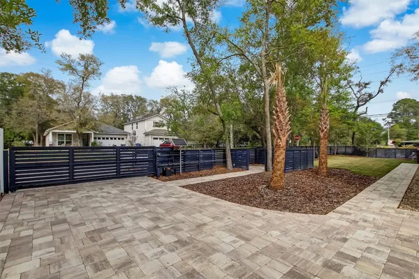 a backyard of a house with lots of green space and garden