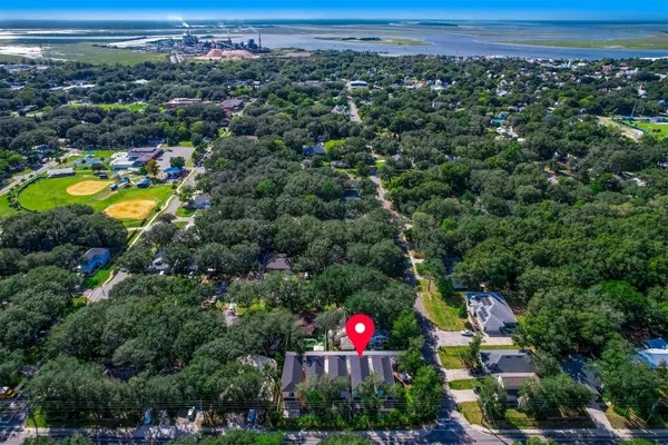 an aerial view of residential houses with outdoor space and swimming pool