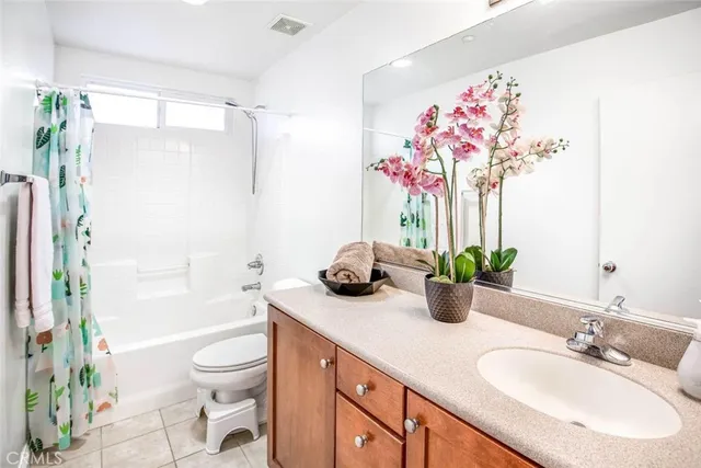 a bathroom with a granite countertop sink a toilet and shower