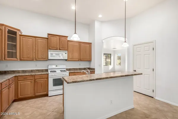 a kitchen with stainless steel appliances granite countertop a sink a stove and a refrigerator