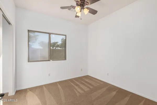 a view of a big room with closet and chandelier fan