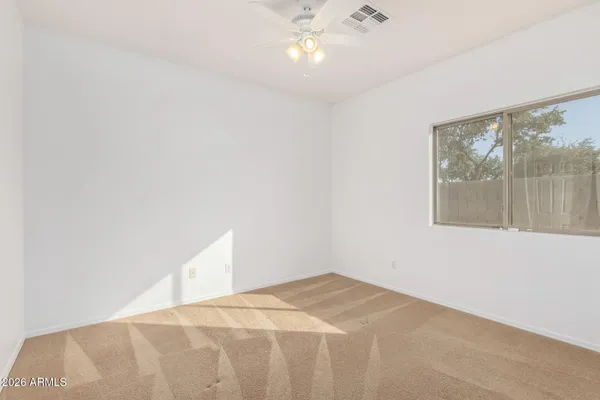 an empty room with a ceiling fan