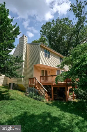 a view of a house with a yard and sitting area