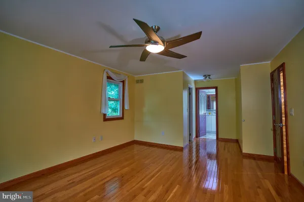 a view of a room with wooden floor