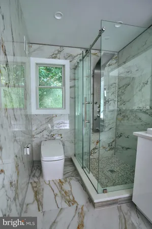 a bathroom with a double vanity sink toilet and shower