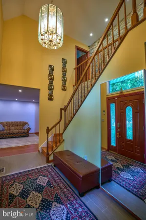 a view of entryway stairs and hall with wooden floor