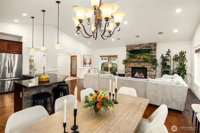 a living room with furniture a fireplace and a chandelier