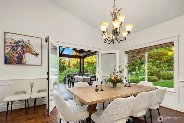 a view of a dining room with furniture a large window a livingroom and mountain view