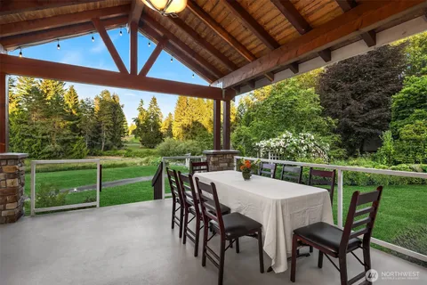 a view of a patio with a table chairs and a backyard