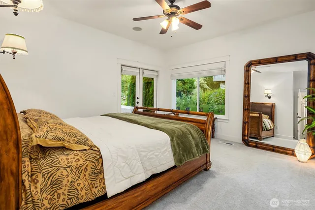 a bedroom with a bed and ceiling fan