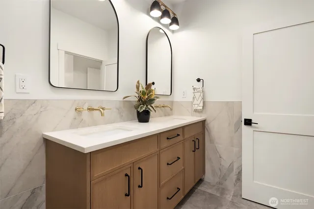 a bathroom with a double vanity sink and a mirror