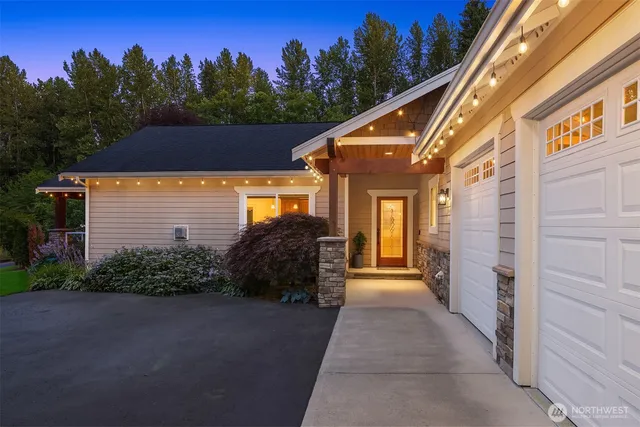 a view of a house with a yard and potted plants