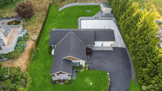 an aerial view of a house with a garden and trees