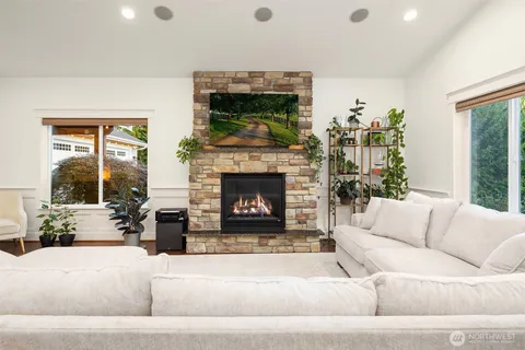 a living room with furniture large window and a fireplace