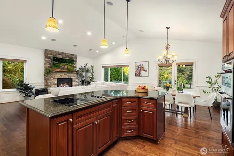 a kitchen with a sink stove and wooden floor