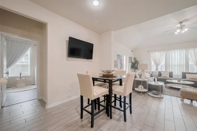 a living room with furniture and view of kitchen