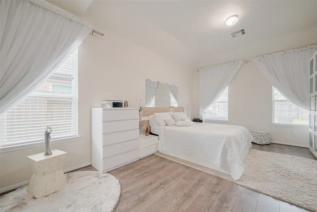 a bathroom with a tub sink vanity and mirror