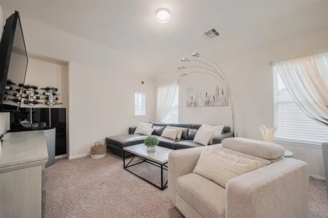 a living room with furniture and a large window