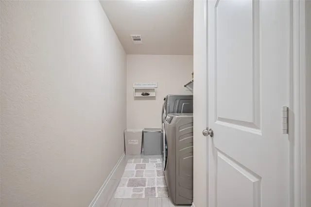 a bedroom with a bed and a computer on the desk