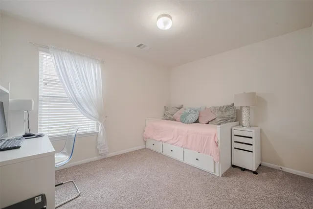 a bedroom with a bed and a lamp