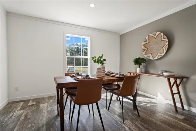 a dining room with furniture and window