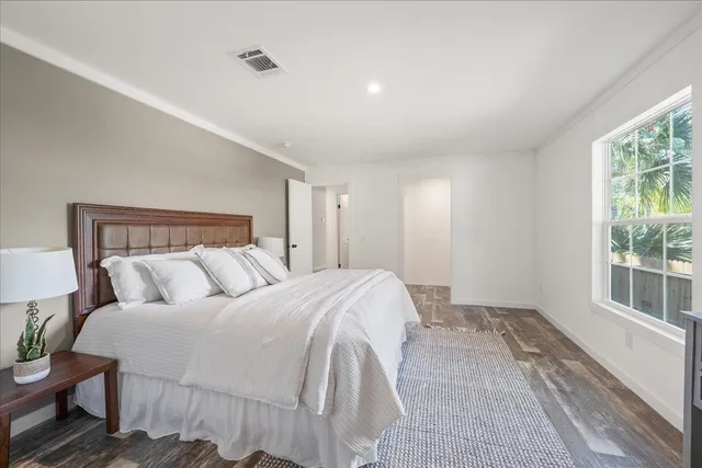 a bedroom with a bed and a window