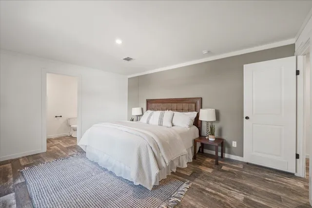 a bedroom with a bed and a mirror