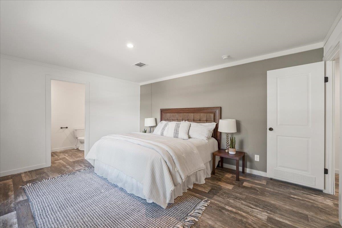 3500 Atcheson Street St. Augustine, FL 32084 - Photo 13 of 29 Bedroom featuring ornamental molding, dark wood finished floors, and ensuite bath