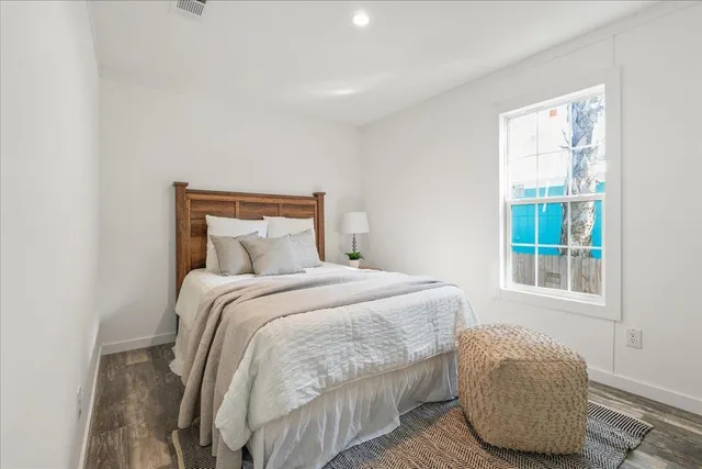 a bedroom with a bed and window