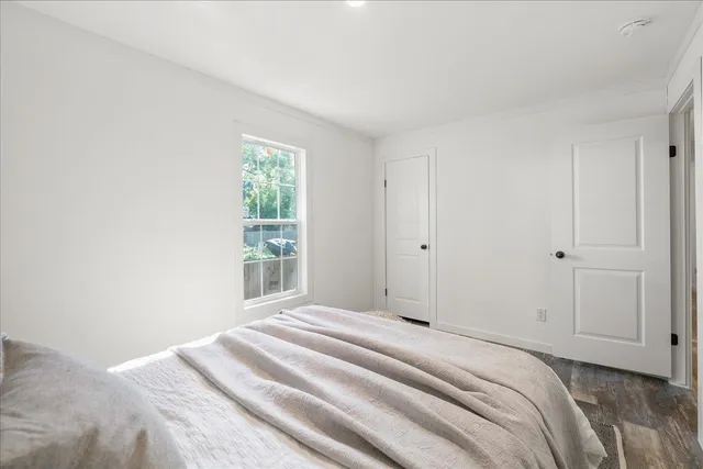 a bedroom with a bed and a window