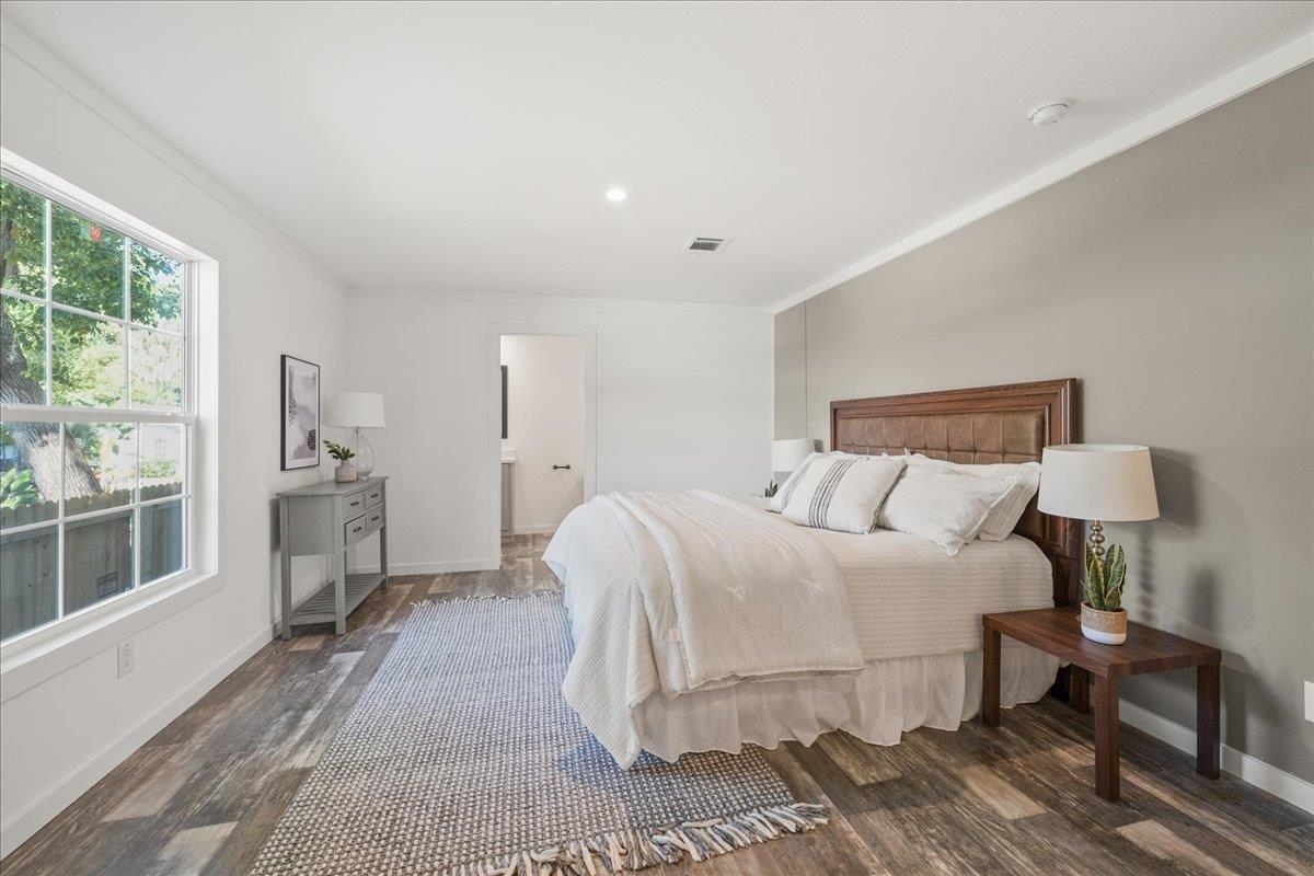 3500 Atcheson Street St. Augustine, FL 32084 - Photo 3 of 29 Bedroom featuring ornamental molding, dark wood finished floors, and connected bathroom
