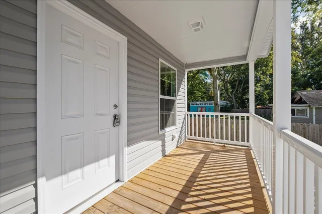 a view of a balcony with wooden floor