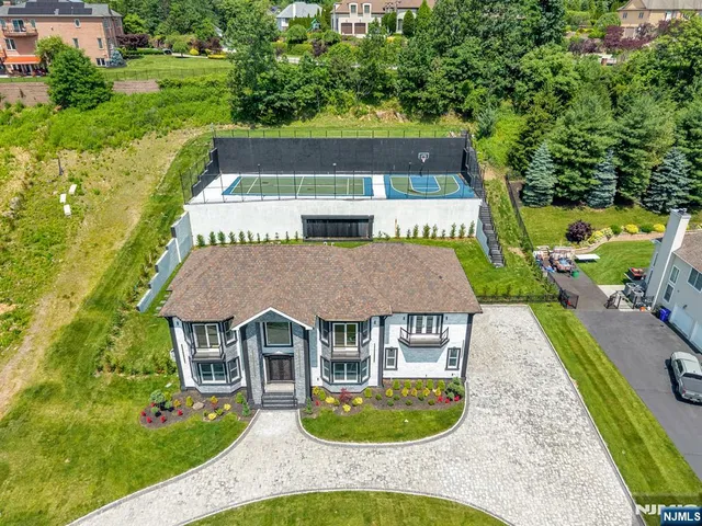 an aerial view of a house with swimming pool garden and patio
