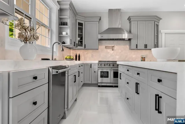a kitchen with stainless steel appliances a sink stove and cabinets