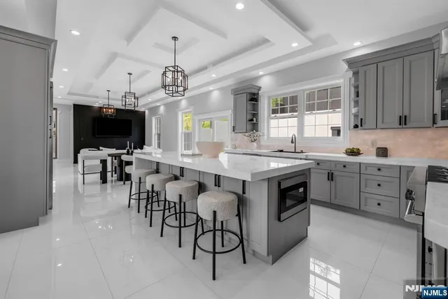 a kitchen with stainless steel appliances a stove sink microwave and cabinets