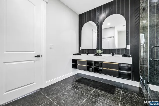 a bathroom with a double vanity sink and a mirror